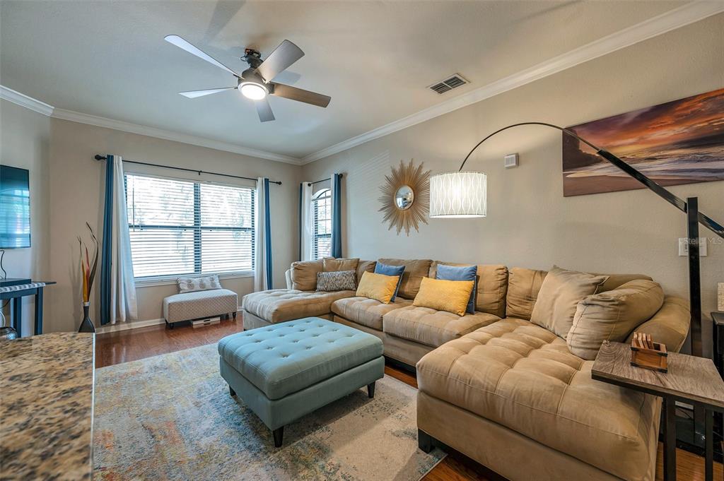 2245 Chianti Place, Unit 724 Palm Harbor, FL 34683 - Photo 6 of 76 a living room with furniture ceiling fan and a window