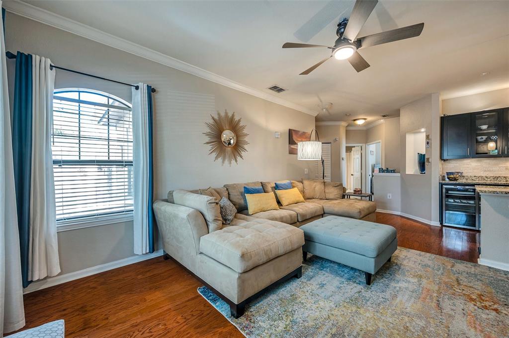 2245 Chianti Place, Unit 724 Palm Harbor, FL 34683 - Photo 7 of 76 a living room with furniture and a flat screen tv