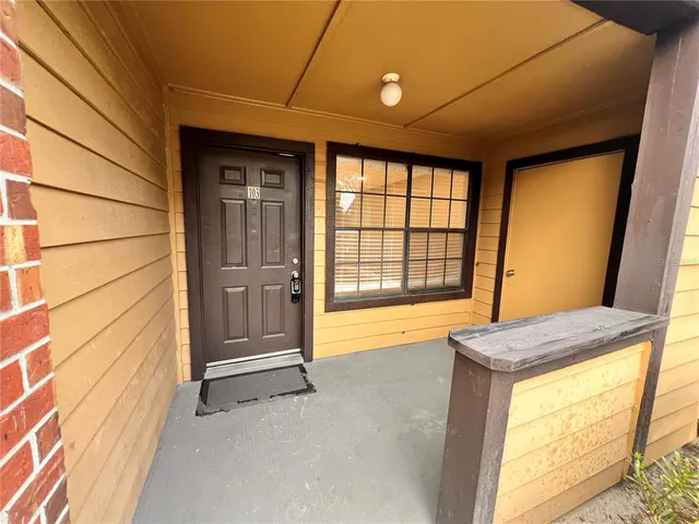 a view of an empty room with a fireplace and a window