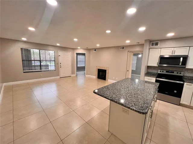 a kitchen with stainless steel appliances granite countertop a sink and a stove top oven