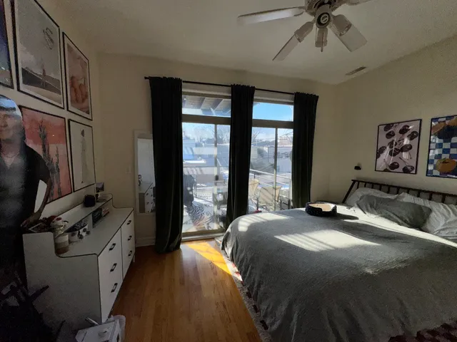 a bedroom with a bed and a flat tv screen on dresser