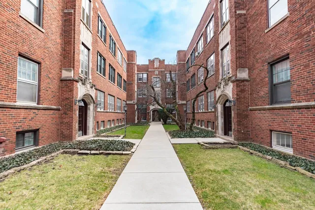 a view of a brick building next to a yard