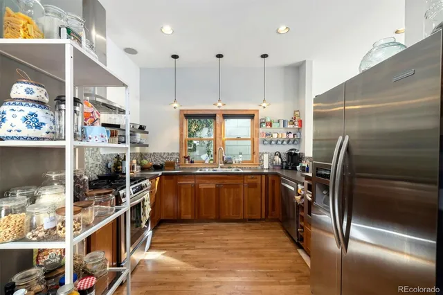 a kitchen with stainless steel appliances granite countertop a stove and a refrigerator
