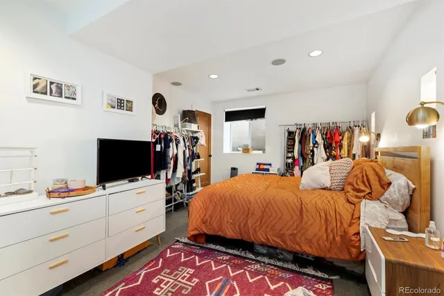 a bedroom with bed and window