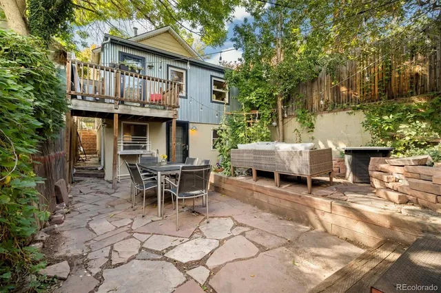 a view of a patio with table and chairs and potted plants