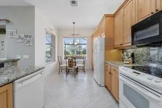 a view of a dining room with furniture and chandelier