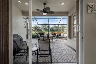 a dining room with furniture a rug and a large window