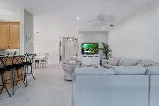 a view of a kitchen with furniture and wooden floor