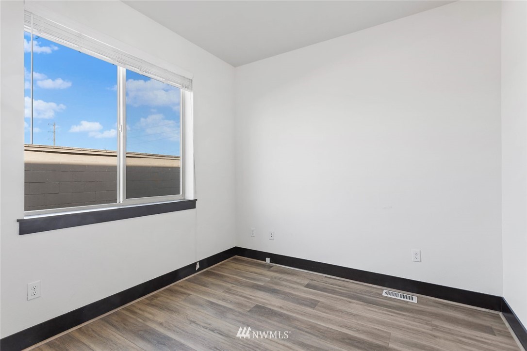 4004 Northeast 3rd Place Renton, WA 98056 - Photo 11 of 25 a view of an empty room with wooden floor and a window