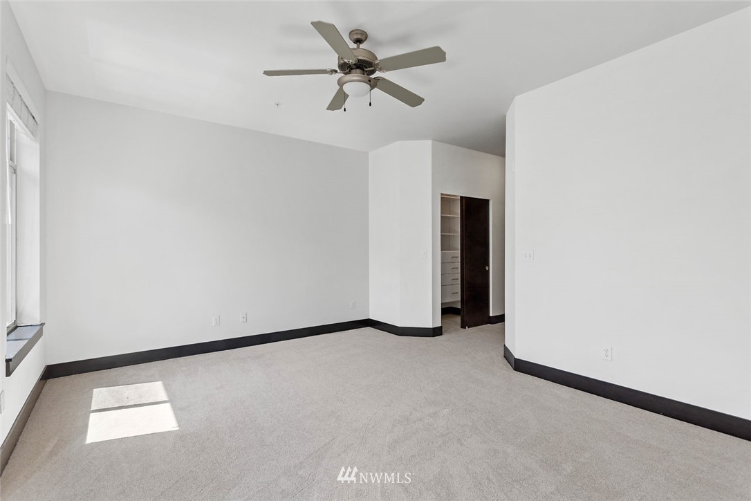 4004 Northeast 3rd Place Renton, WA 98056 - Photo 17 of 25 an empty room with a ceiling fan and a window