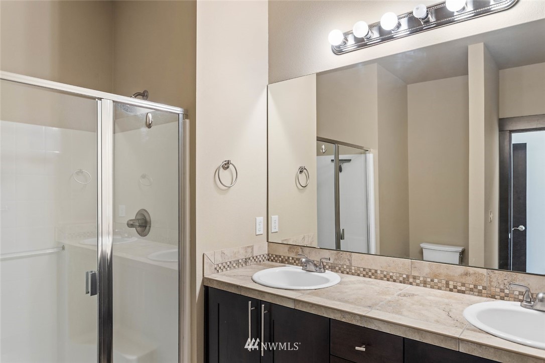 4004 Northeast 3rd Place Renton, WA 98056 - Photo 20 of 25 a bathroom with a granite countertop sink and a mirror
