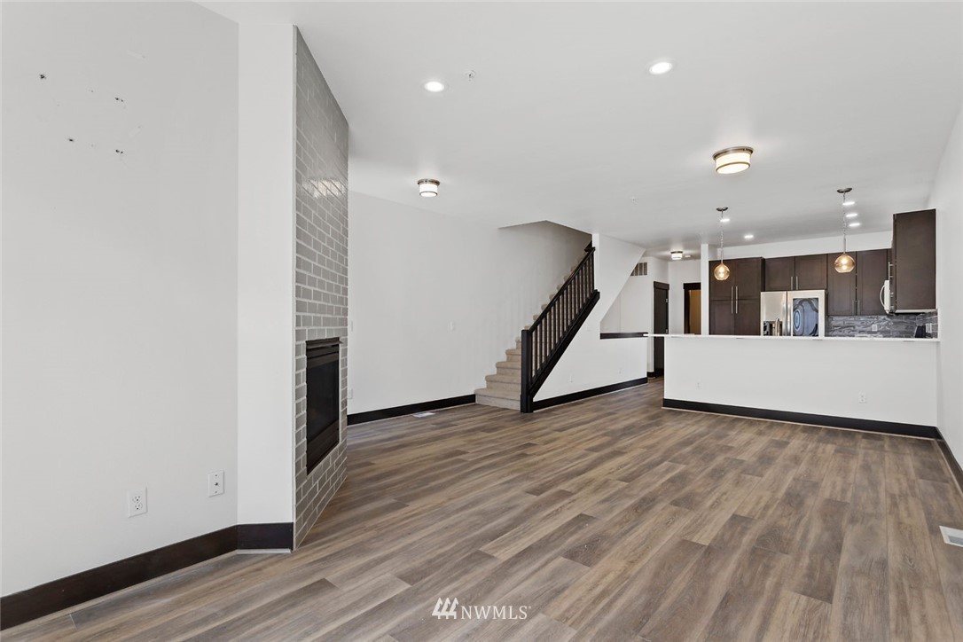 4004 Northeast 3rd Place Renton, WA 98056 - Photo 5 of 25 a view of a hallway with wooden floor and staircase