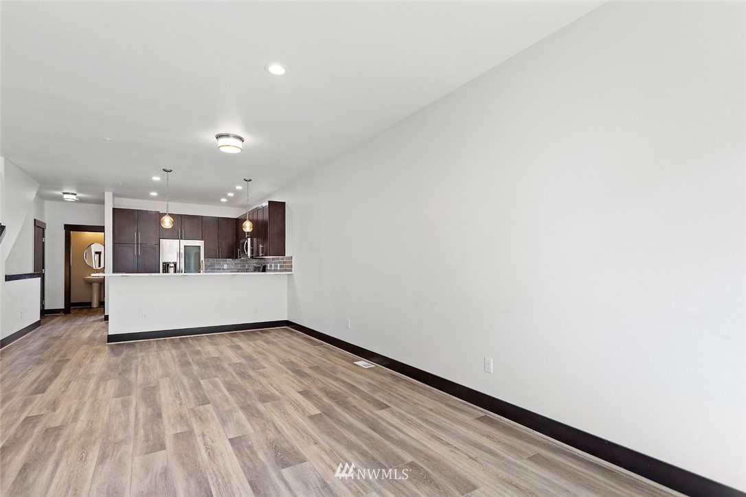 4004 Northeast 3rd Place Renton, WA 98056 - Photo 7 of 25 a view of a big room with wooden floor and windows