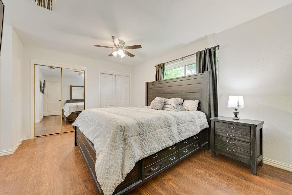 905 Pepperidge Court Lancaster, TX 75134 - Photo 12 of 19 a bedroom with a bed and a chandelier