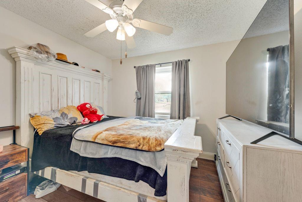 905 Pepperidge Court Lancaster, TX 75134 - Photo 15 of 19 a bedroom with a bed and a chandelier
