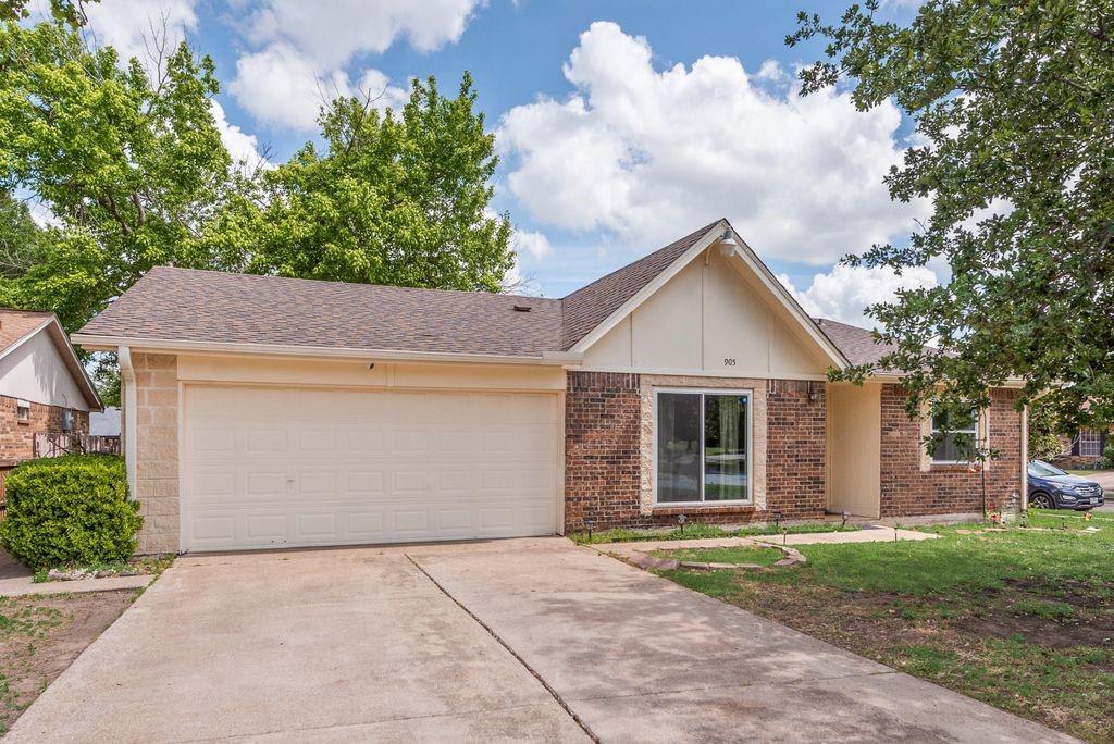905 Pepperidge Court Lancaster, TX 75134 - Photo 16 of 19 front view of house with a yard and an trees