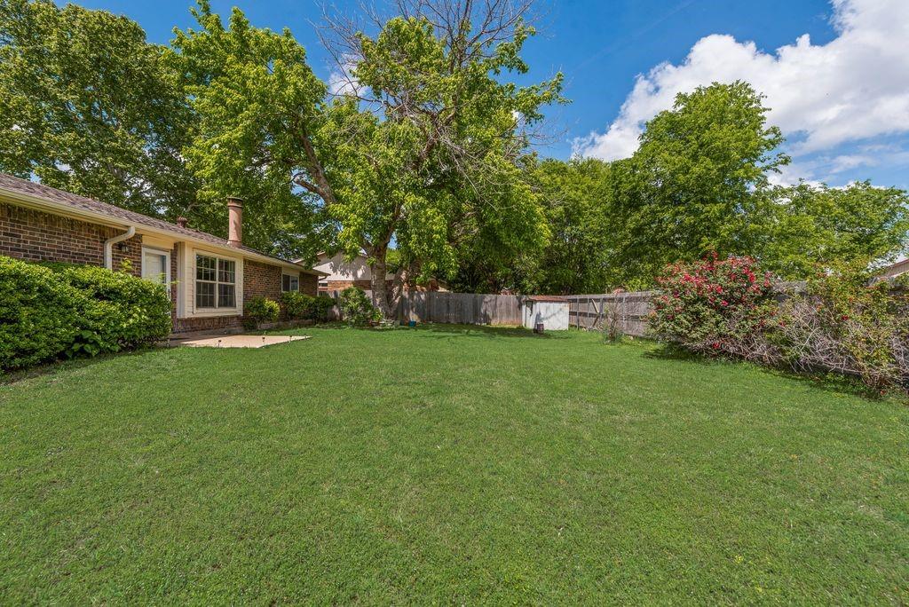 905 Pepperidge Court Lancaster, TX 75134 - Photo 19 of 19 a view of a house with backyard and garden