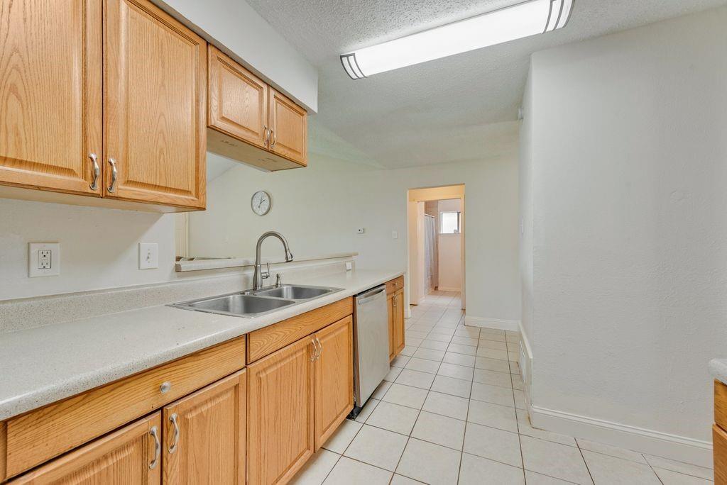 905 Pepperidge Court Lancaster, TX 75134 - Photo 6 of 19 a kitchen with stainless steel appliances granite countertop a sink and a white cabinets