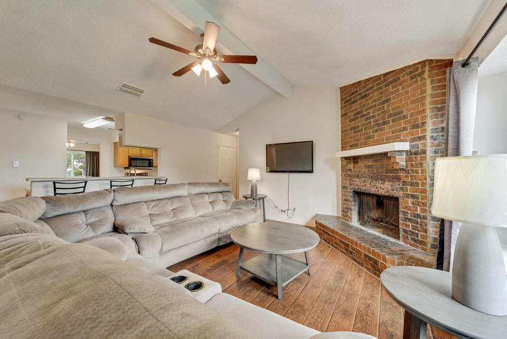 905 Pepperidge Court Lancaster, TX 75134 - Photo 9 of 19 a living room with furniture a fireplace and a flat screen tv
