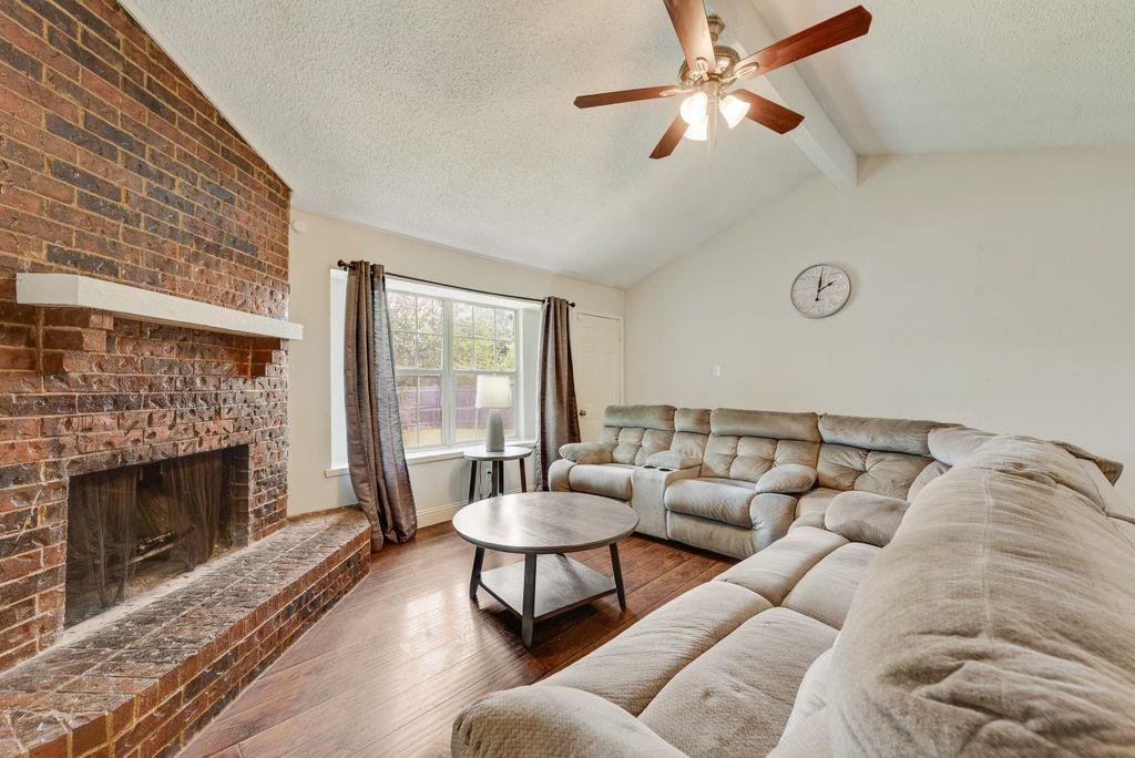 905 Pepperidge Court Lancaster, TX 75134 - Photo 10 of 19 a living room with furniture a window and a fireplace