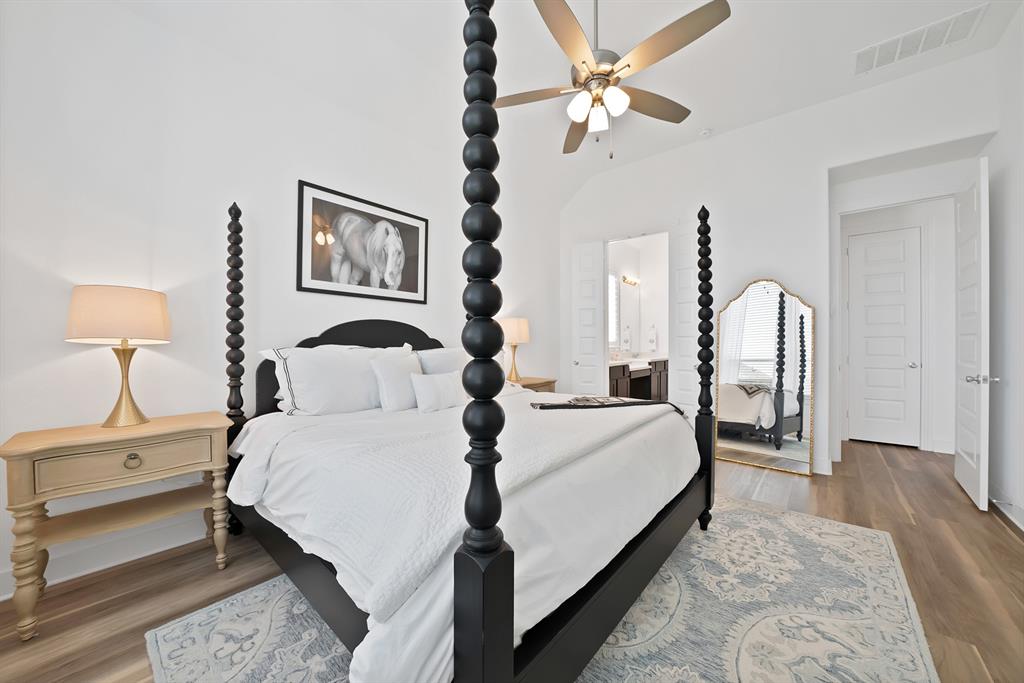 1709 Shetland Road Aubrey, TX 76227 - Photo 15 of 35 a bedroom with a bed and a chandelier