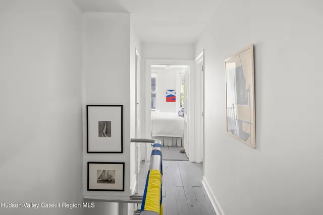 a bedroom with a bed and a large mirror