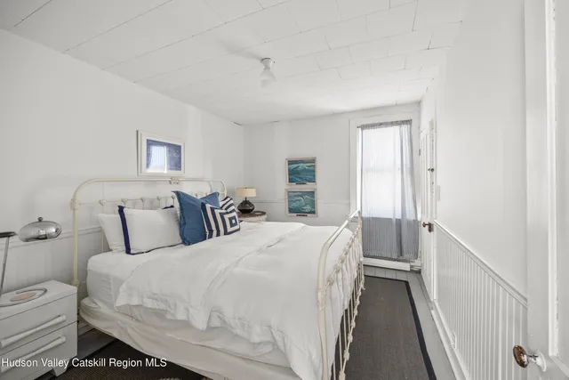 a living room with furniture a window and a chandelier
