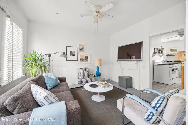 a living room with furniture a flat screen tv and couches