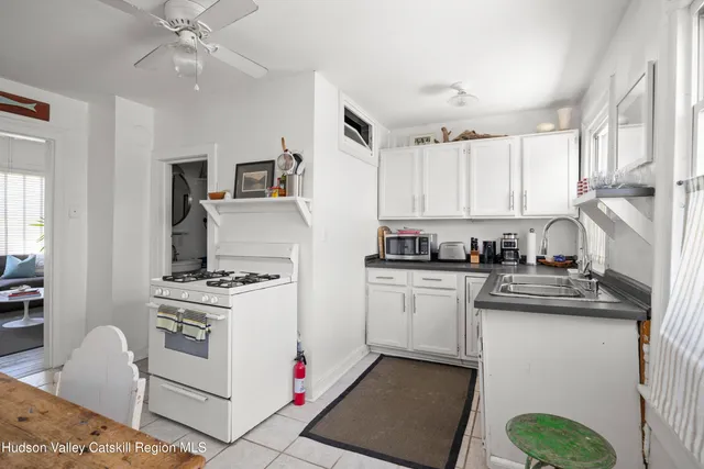 a kitchen with a stove cabinets and window