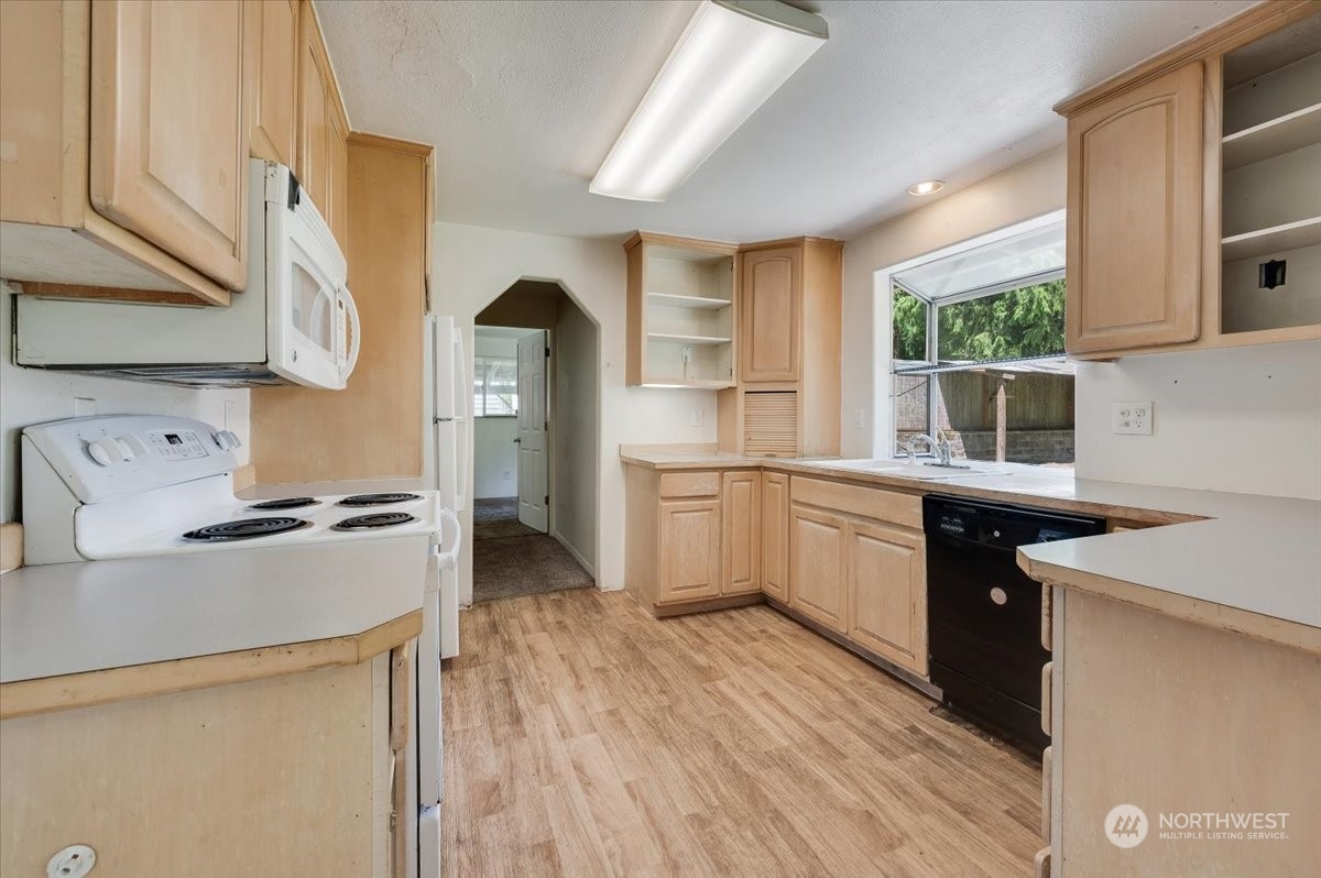 107 231st Street Southeast Bothell, WA 98021 - Photo 11 of 39 a kitchen with a stove a sink and a refrigerator