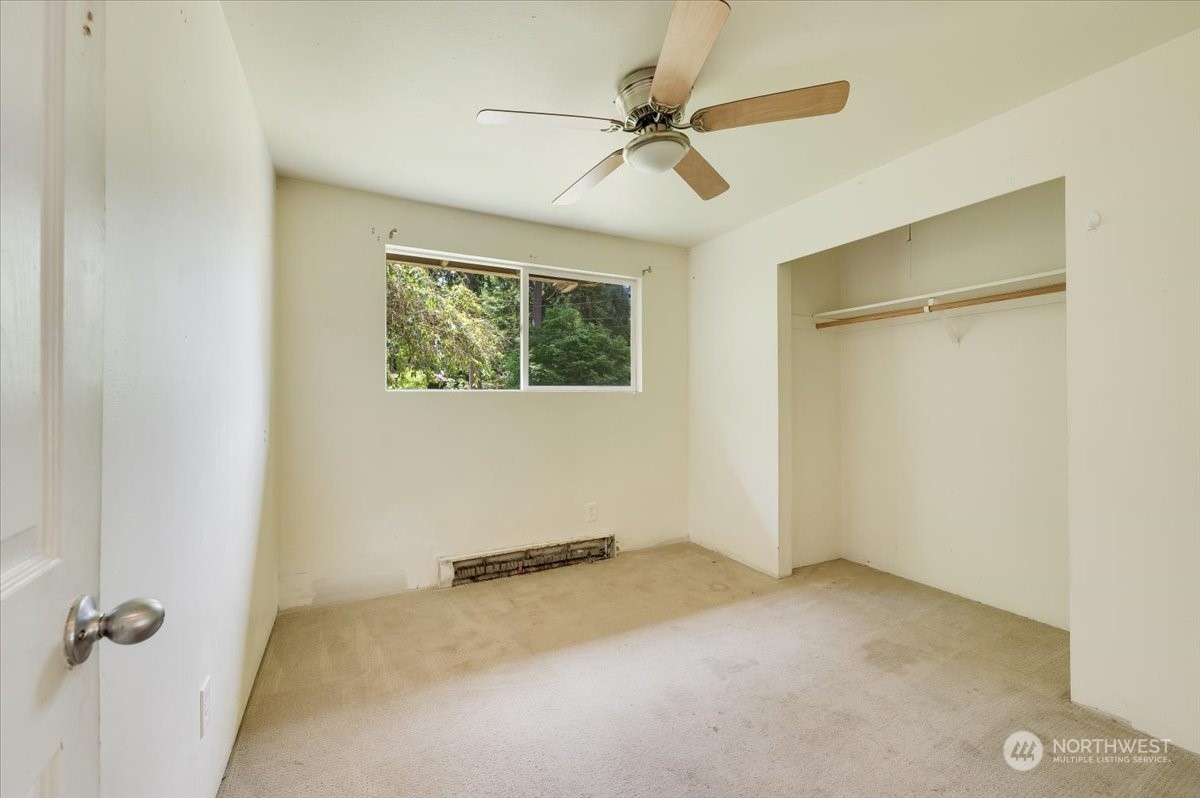 107 231st Street Southeast Bothell, WA 98021 - Photo 15 of 39 an empty room with a ceiling fan and a window