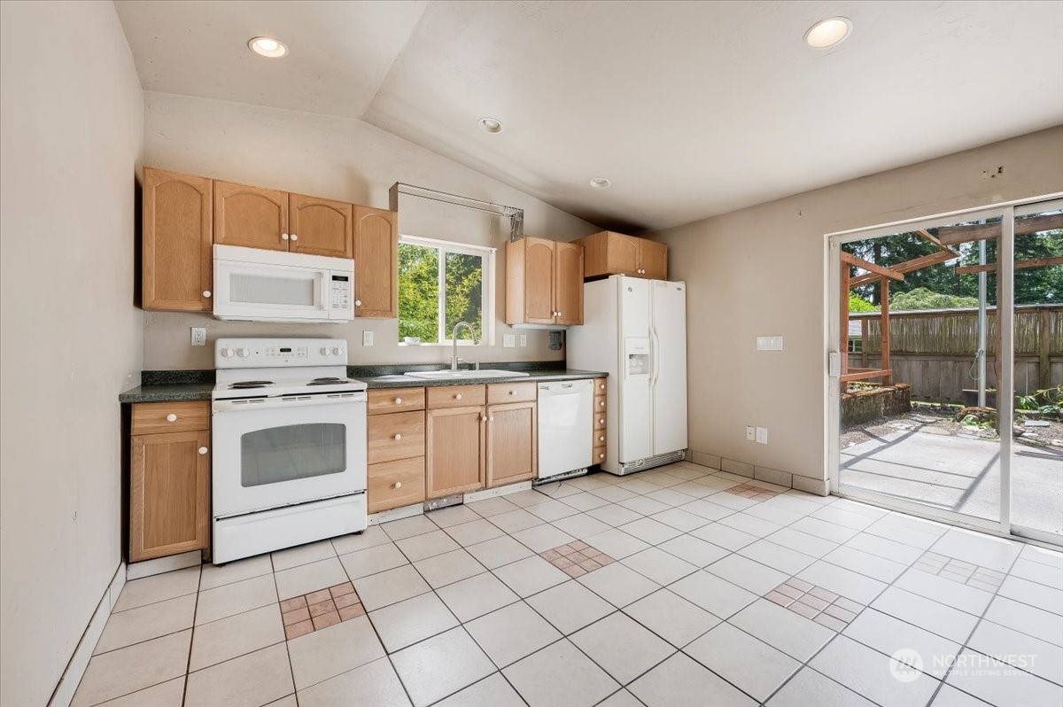 107 231st Street Southeast Bothell, WA 98021 - Photo 31 of 39 a kitchen with a white cabinets and white appliances