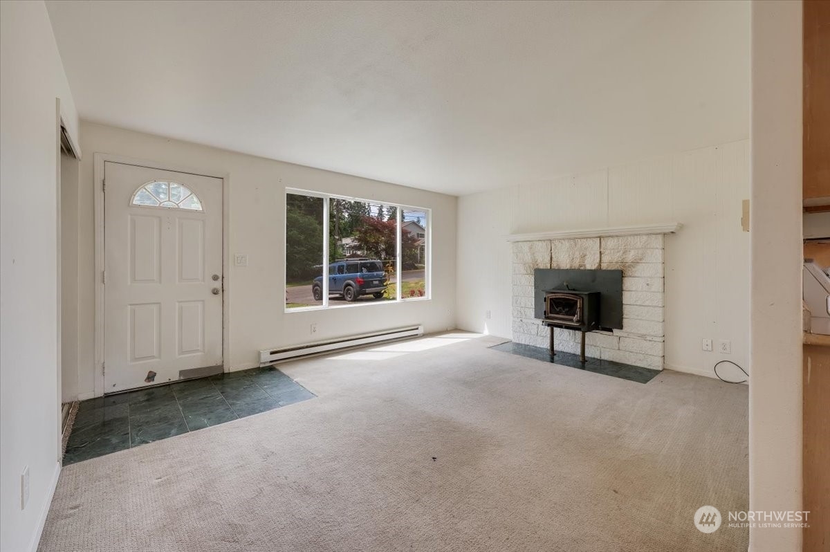 107 231st Street Southeast Bothell, WA 98021 - Photo 7 of 39 an empty room with windows and fireplace