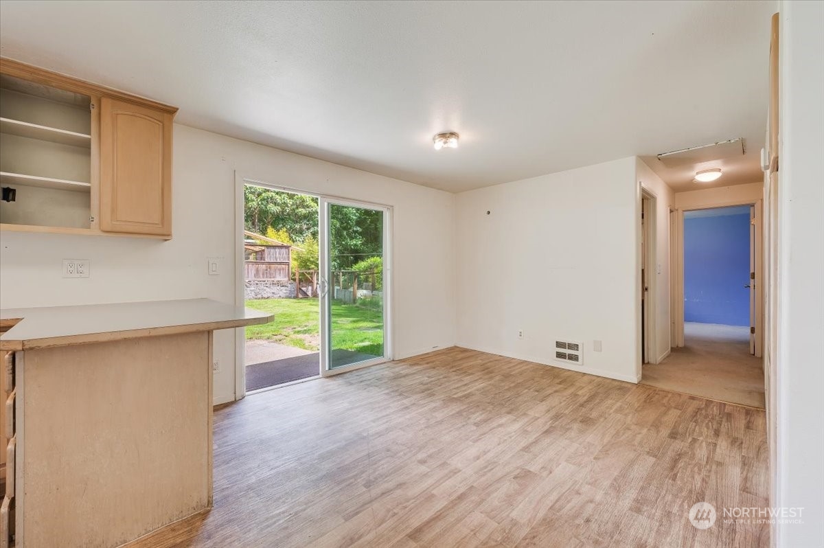 107 231st Street Southeast Bothell, WA 98021 - Photo 8 of 39 a view of an empty room with a window and wooden floor