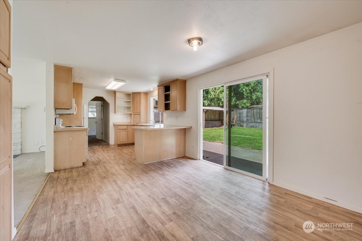 107 231st Street Southeast Bothell, WA 98021 - Photo 9 of 39 a view of a kitchen with wooden floor electronic appliances and windows