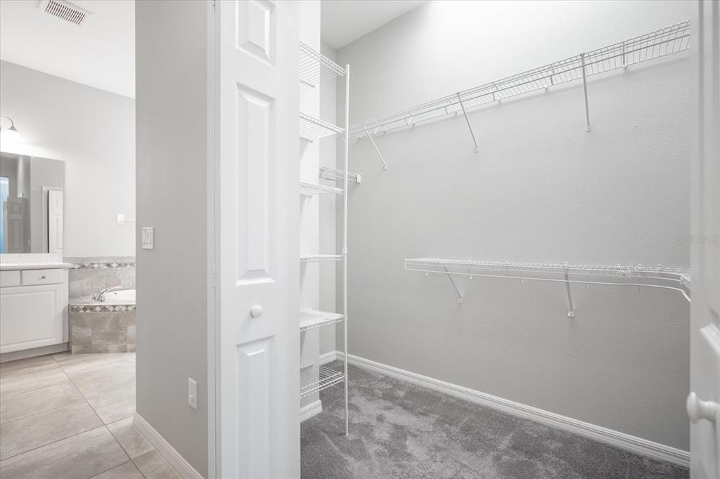 6523 Watson Road Riverview, FL 33578 - Photo 17 of 32 a view of walk in closet with empty racks