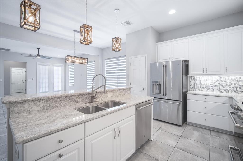 6523 Watson Road Riverview, FL 33578 - Photo 8 of 32 a kitchen with a sink and refrigerator