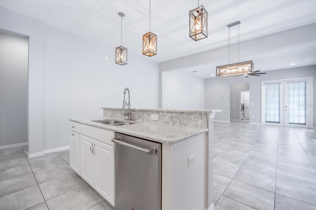 6523 Watson Road Riverview, FL 33578 - Photo 10 of 32 a kitchen with a sink and a refrigerator