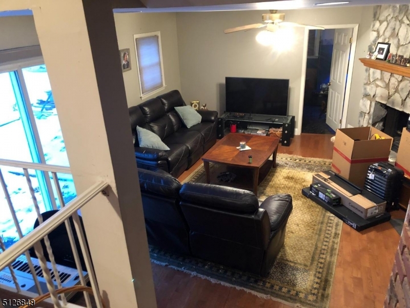 77 Toby Drive Succasunna, NJ 07876 - Photo 3 of 6 a living room with furniture and a flat screen tv