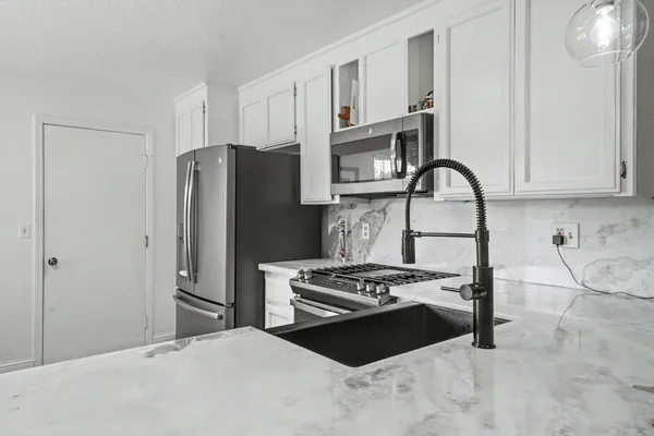 a kitchen with a table chairs sink and cabinets