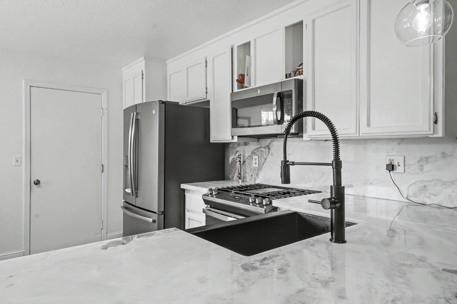 67 St Andrews Road Valley Springs, CA 95252 - Photo 17 of 58 a kitchen with stainless steel appliances a refrigerator a stove and a sink