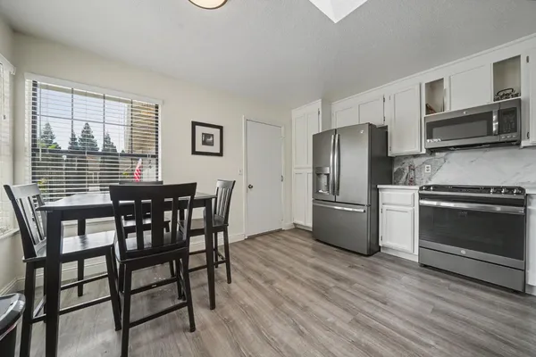 a kitchen that has a table and chairs in it