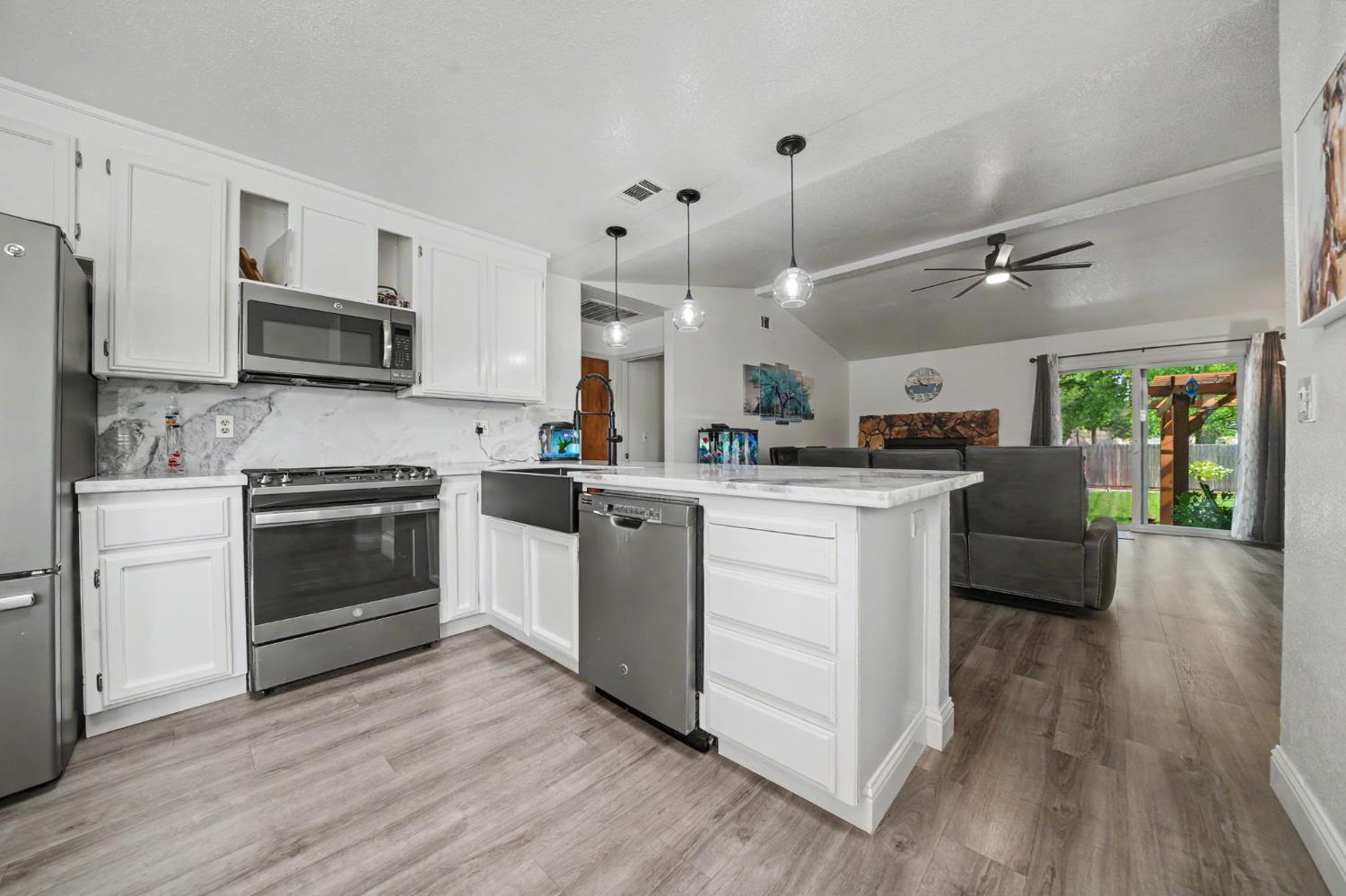 67 St Andrews Road Valley Springs, CA 95252 - Photo 20 of 58 a kitchen with kitchen island white cabinets and stainless steel appliances