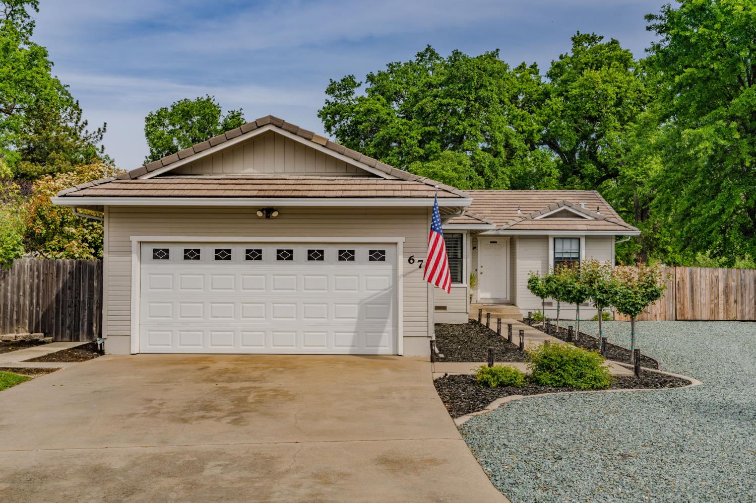 67 St Andrews Road Valley Springs, CA 95252 - Photo 2 of 58 a front view of a house with a yard and garage