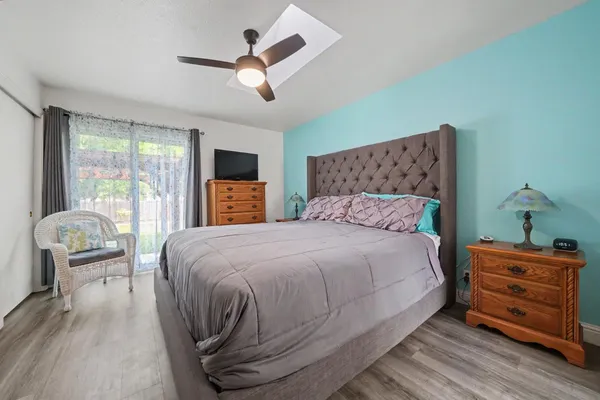 a spacious bedroom with a bed and a ceiling fan