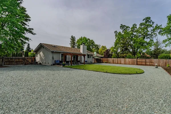 a view of a house with a yard and a garden