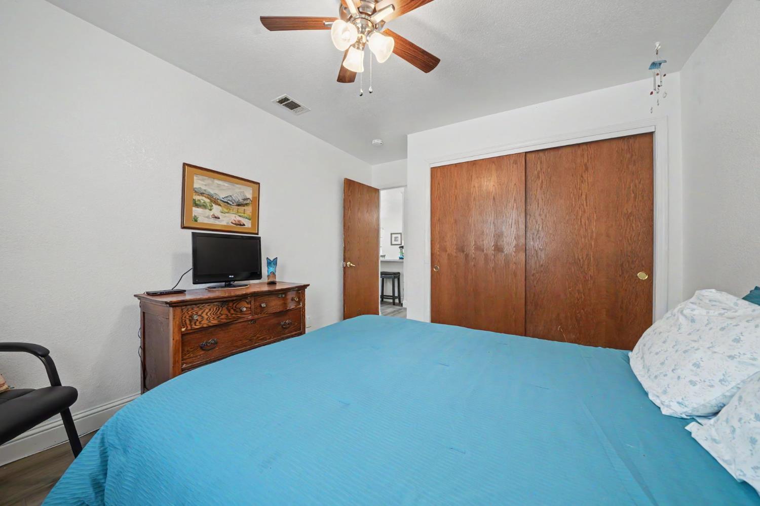 67 St Andrews Road Valley Springs, CA 95252 - Photo 31 of 58 a bedroom with a bed and a flat screen tv