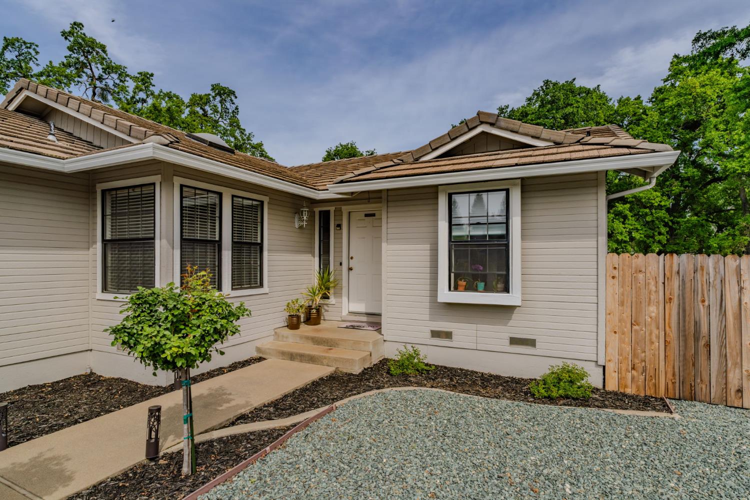67 St Andrews Road Valley Springs, CA 95252 - Photo 42 of 58 a front view of a house with a yard and potted plants