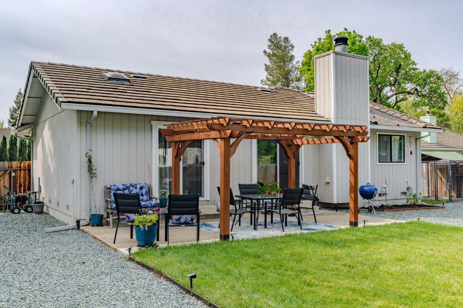 67 St Andrews Road Valley Springs, CA 95252 - Photo 44 of 58 a view of a chairs and tables in the back yard of the house
