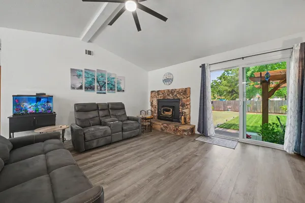a living room with furniture large window and a fireplace